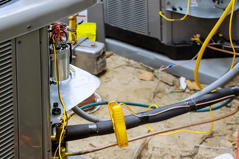 Commercial HVAC Systems: How to Budget for Replacement. Close up photo of an HVAC Unit installed.